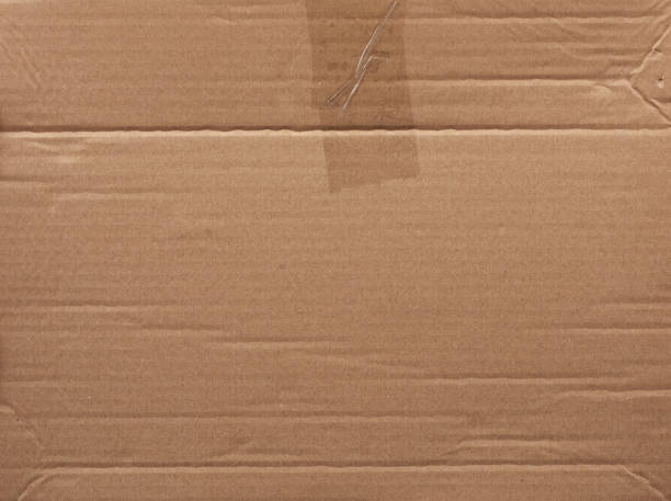 istock piece of smooth brown cardboard paper, full frame 1201918048