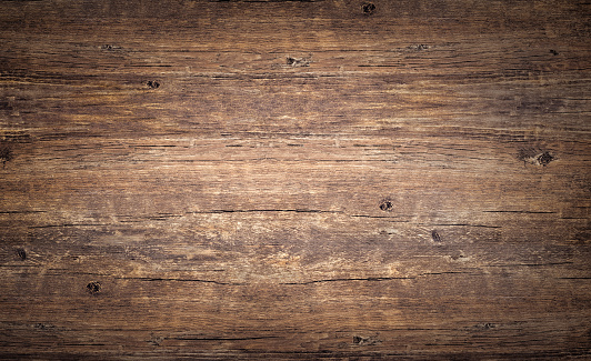 Wood texture background. Top view of vintage wooden table with cracks. Brown rustic rough timber for backdrop.