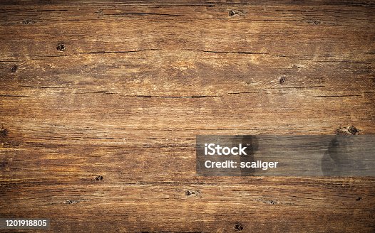 istock Wood texture background. Top view of vintage wooden table with cracks. Surface of old knotted wood with natural color, texture and pattern. Dark barn material. 1201918805