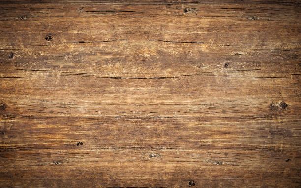 wood texture background. top view of vintage wooden table with cracks. surface of old knotted wood with natural color, texture and pattern. dark barn material. - wood table imagens e fotografias de stock