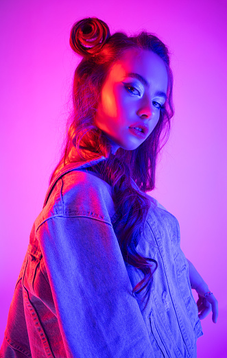 Fashion model Girl in Neon Lights. Beautiful studio photo in colorful bright lights.