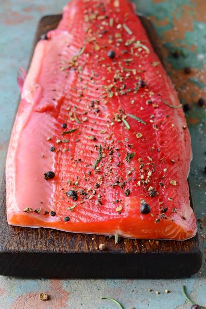 istock Gravlax, scandinavian beet cured spiced salmon on the board, top view, salted red fish 1201920083