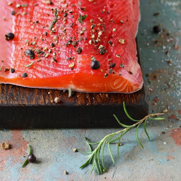 istock Gravlax, scandinavian beet cured spiced salmon on the board, top view, salted red fish 1201920091