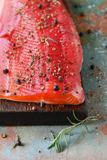 istock Gravlax, scandinavian beet cured spiced salmon on the board, top view, salted red fish 1201920092