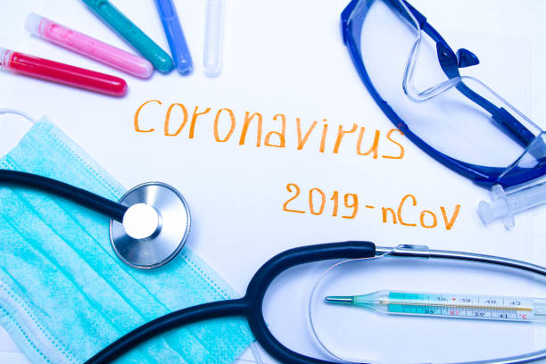 istock Coronavirus diagnostic and treatment analysis concept. Laboratory table with a respiratory mask, a stethoscope, blood tubes, tablets. 2019 nCoV Coronavirus originating in Wuhan, China. 1201920312