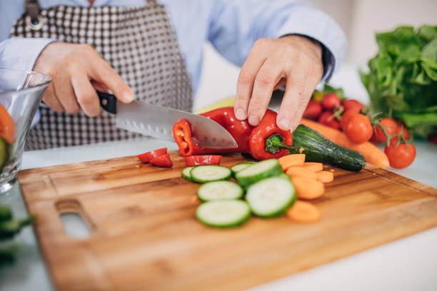 istock a man's hands cut vegetables with a knife 1201920353