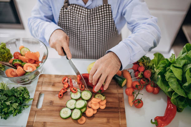 istock a man's hands cut vegetables with a knife 1201921220