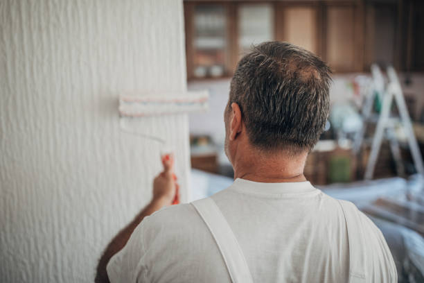 istock The painter decorates the apartment, paints the walls 1201921592