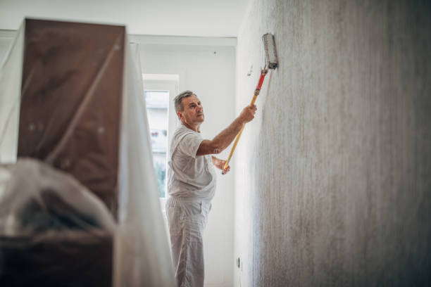 istock The painter is making new flats, painting the walls 1201921690