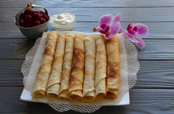 istock Pancakes on a plate with milk mousse and cherries. 1201921697