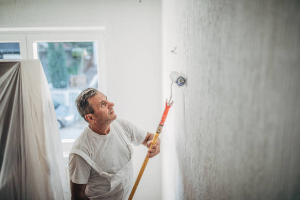 istock The painter is making new flats, painting the walls 1201922907