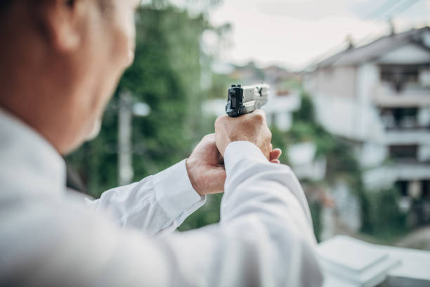 istock Senior man with a gun in his hand 1201927767