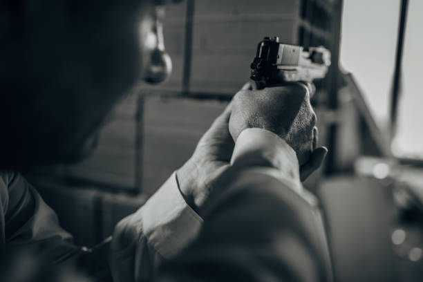 istock a man with a gun in his hand 1201927895