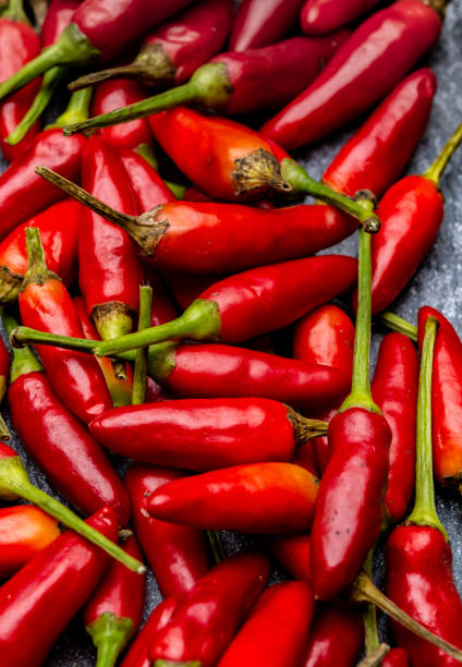 istock Fresh small red hot chili peppers on grey background 1201931235