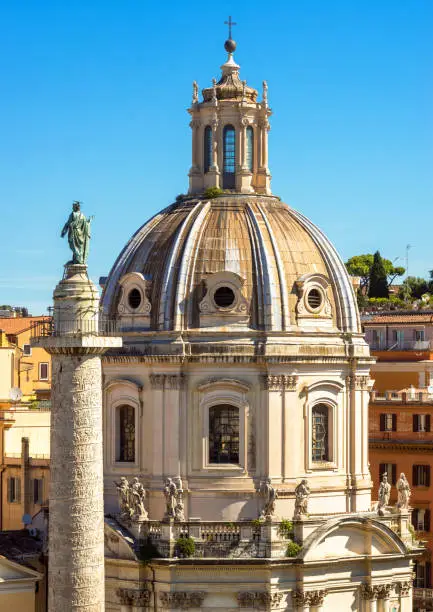 Photo of Rome in summer, Italy. Church of Santa Maria di Loreto and Ancient Roman Trajan's Column in Rome center. Beautiful scenery of Rome with old buildings.