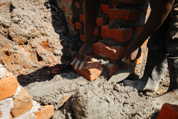 istock Man building a brick wall in Uganda 1201939572
