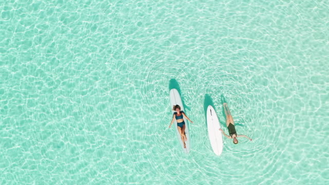 Two women on paddle board in lagoon