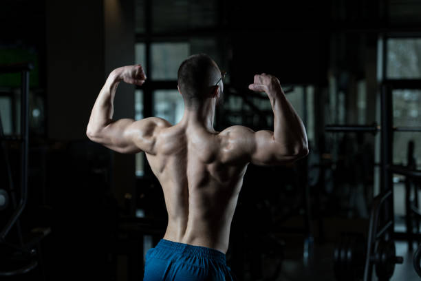 istock Muscular Man Flexing Muscles In Gym 1201943459