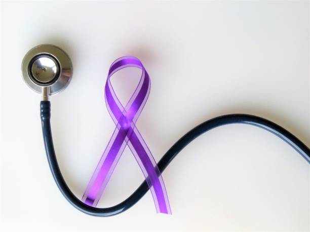 Purple ribbon, stethoscope--Awareness month: pancreatic cancer, epilepsy, Alzheimer's, lupus,  Crohn's, cystic fibrosis, fibromyalgia, sarcoidosis, thyroid cancer, opioids Purple ribbon, stethoscope, awareness of pancreatic cancer, epilepsy, Alzheimer's, lupus, Crohn's, cystic fibrosis, fibromyalgia, sarcoidosis, thyroid cancer, opioids. White background. Copy Space. Christine Kohler stock pictures, royalty-free photos & images
