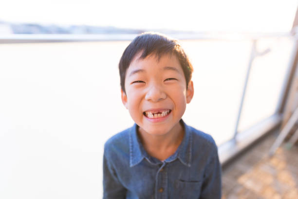 Portrait of smiling six year old boy with missing milk teeth.