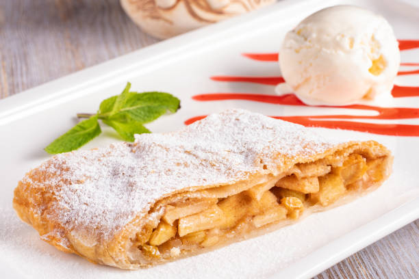 Apple strudel with a ball of creamy ice cream. Apple strudel with a ball of creamy ice cream. apple strudel stock pictures, royalty-free photos & images