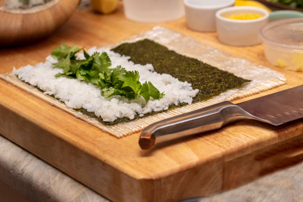 istock Chef preparing ingredients and teaching how to make Sushi 1201986221