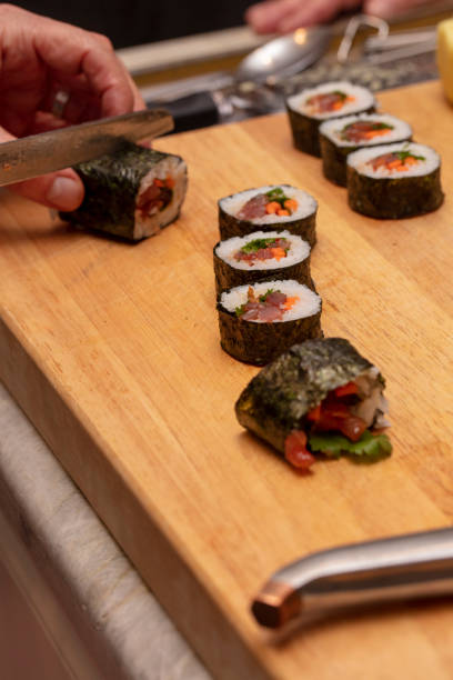 istock Sushi roll being sliced in a demonstaration class 1201986222