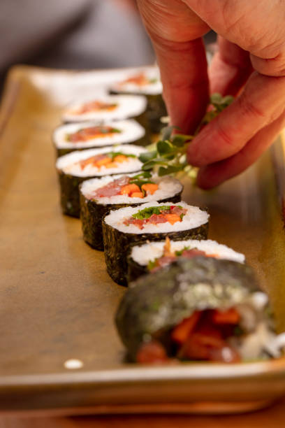 istock Sushi roll being sliced in a demonstaration class 1201986242