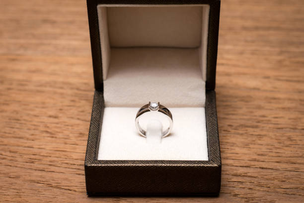 istock Diamond wedding ring in the box on wooden table. 1201987799