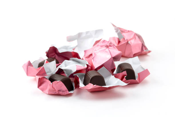 Pink heart shaped petit fours cakes seen from above on a pink background