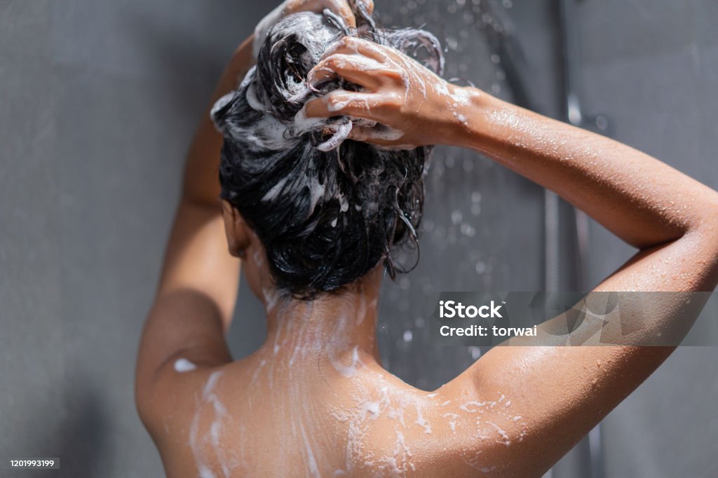 Woman bathing and washing her hair relaxed. Hair Stock Photo