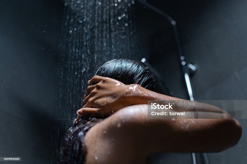 Woman bathing and washing her hair relaxed. Taking a Bath Stock Photo