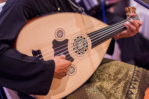 A man playing a Gambus on a wedding event, a musical instrument used for the famous Ghazal traditional song in the state of Johor.
