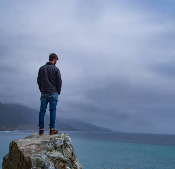istock Man Overlooking the Ocean at Big Sur 1201994907