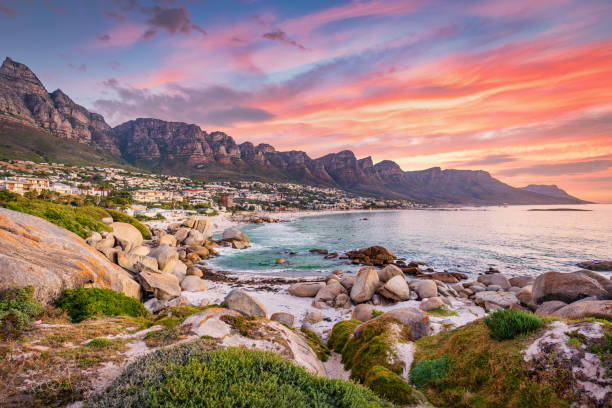Camps Bay Cape Town Vibrant Sunset Twilight South Africa Beautiful sunset twilight view to Camps Bay, Scenic view during colorful sunset with beautiful cloudscape. Camps Bay the famous suburb of the city of Cape Town with white sandy beaches underneath the Table Mountain. Camps Bay, Cape Town, South Africa, Africa cape peninsula stock pictures, royalty-free photos & images