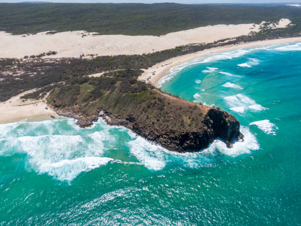 High angle aerial drone view of famous Indian Head headland which marks both the most easterly point on the island and the northern end of 75 Mile Beach on Fraser Island, Queensland, Australia. High angle aerial drone view of famous Indian Head headland which marks both the most easterly point on the island and the northern end of 75 Mile Beach on Fraser Island, Queensland, Australia. fraser island stock pictures, royalty-free photos & images