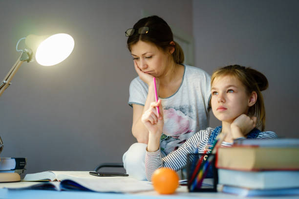 istock Happy Young Mother Helping Her Daughter While Studying At Home getting ready for school 1202003593