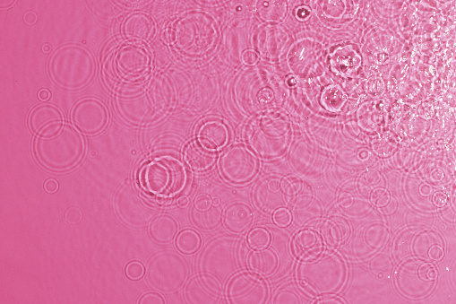 texture of splashing clean water on pink background