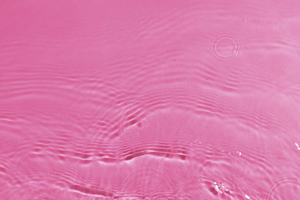 istock texture of splashing clean water on pink background 1202005256