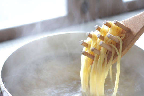 istock Pasta boiled and scooped with tongs 1202005350