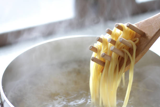 istock Pasta boiled and scooped with tongs 1202005362