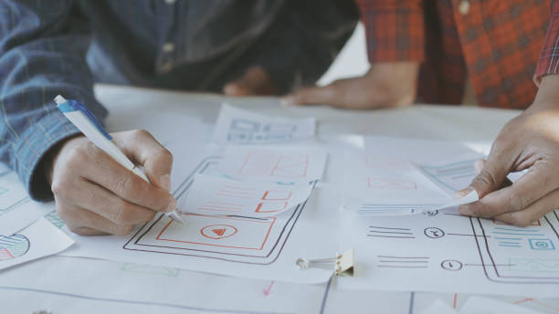 istock Designers man drawing (UX) (UI) Graphic designer creative sketch planning application process development prototype for application on smartphone 1202007856