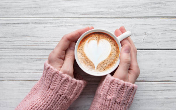 istock Woman holding cup of coffee 1202008290
