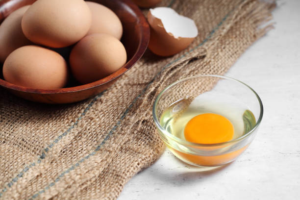 istock Group of of raw chicken eggs on rustic background, Ingredient for Scrambled eggs in loft style kitchen 1202008494