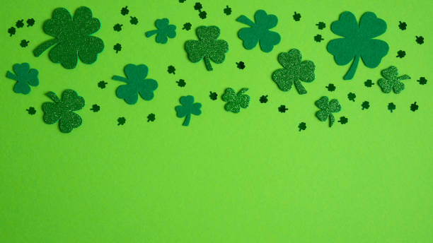 istock St Patricks Day banner design with shamrock and four-leaf clover. Flat lay, top view. Happy St. Patrick's Day concept 1202009407