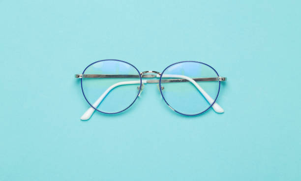 istock Eye glasses isolated on blue background 1202009623