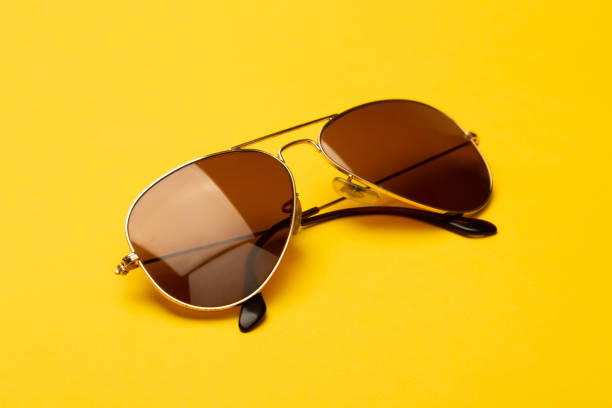 istock Sunglasses isolated on yellow background 1202009660