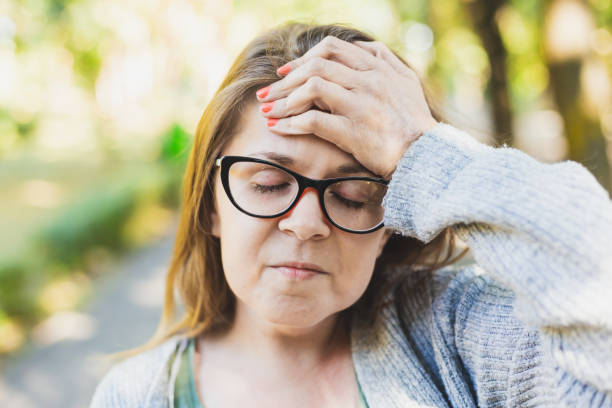 istock Woman having headache with her hand on her forehead 1202011094
