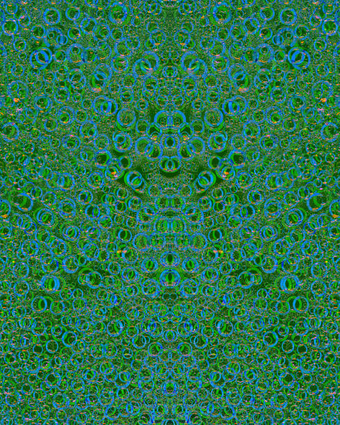 istock Pattern of randomly interwoven rings of different diameters and green and blue colors symmetrically located on a dark green background. Abstract fantasy. 1202013631