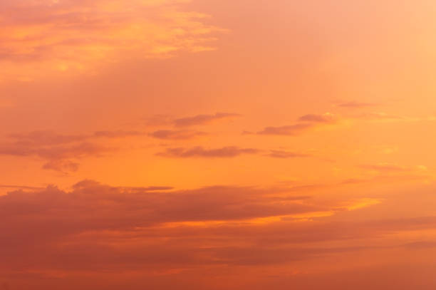 Abstract nature background. Dramatic sunset sky in the clouds saturated with bright colors of orange and yellow. Contrast Low Key.